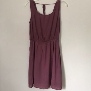 Plum sleeveless, backless mini dress.
